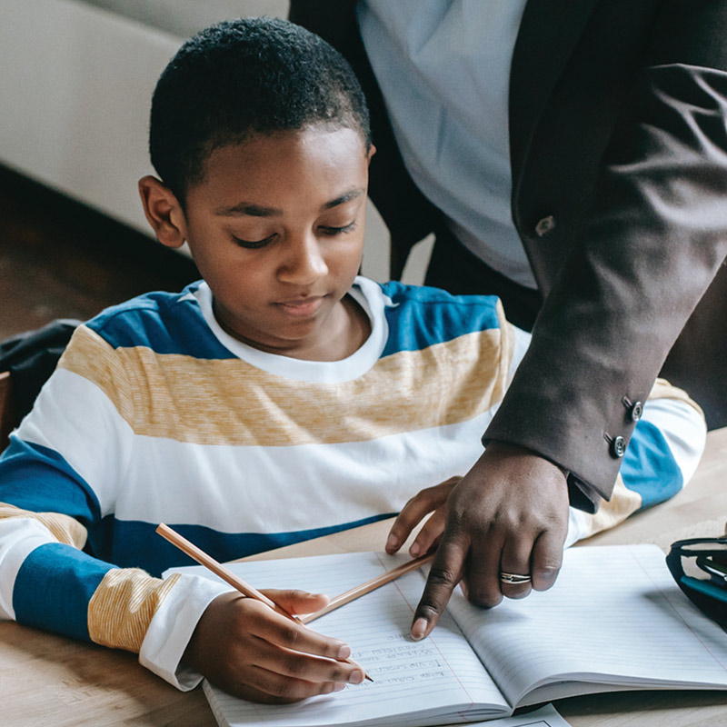 a child with notebook and pencil